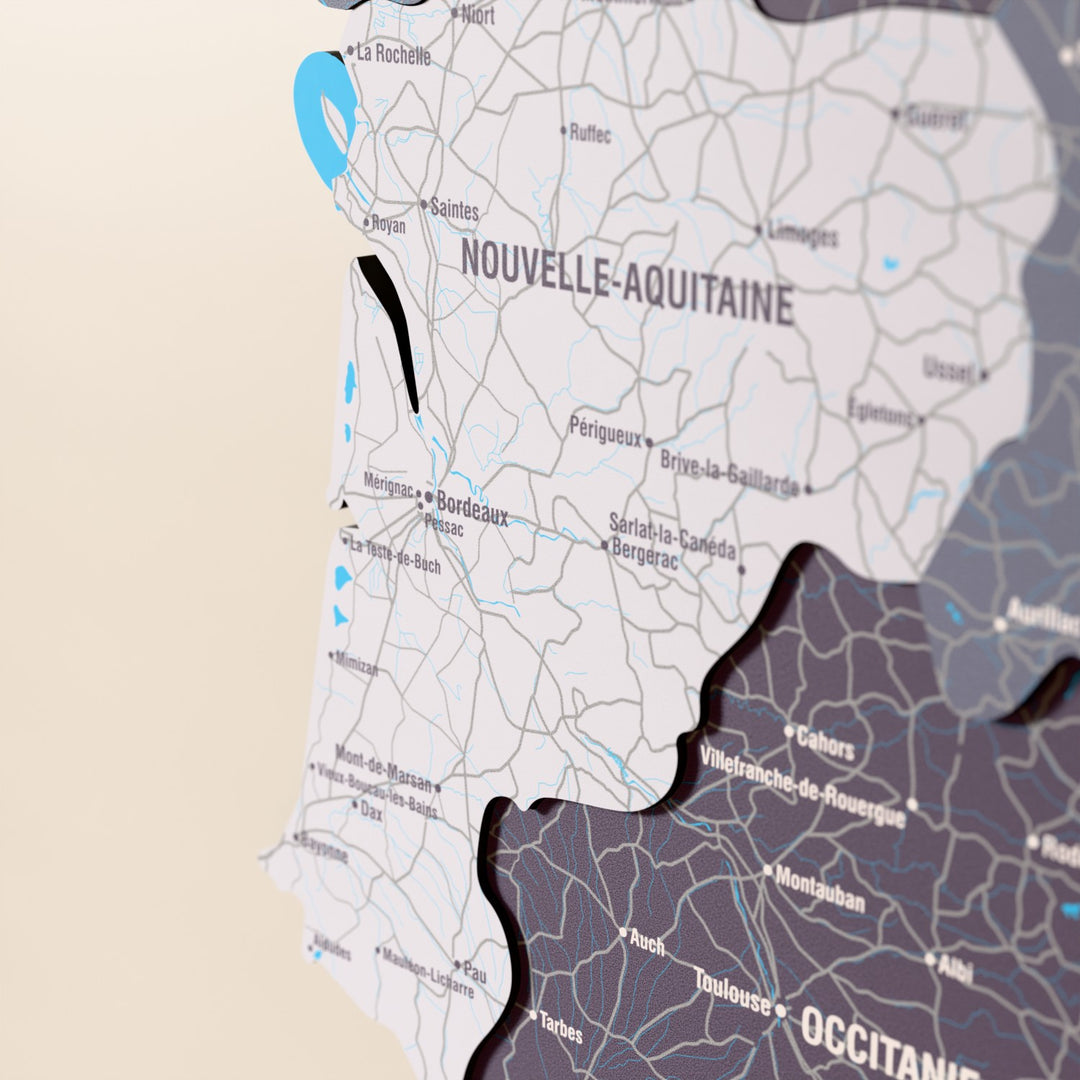 Close-up of the Nimbus France wooden wall map with layered regions and printed names