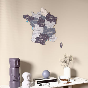 Nimbus France wooden wall map on a beige wall above a console with figurines