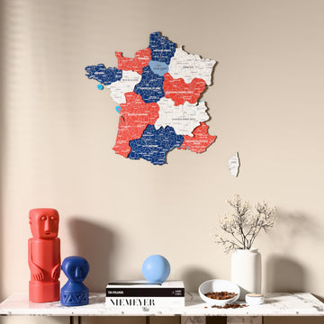 Flag colored France wooden wall map above a marble console, front view