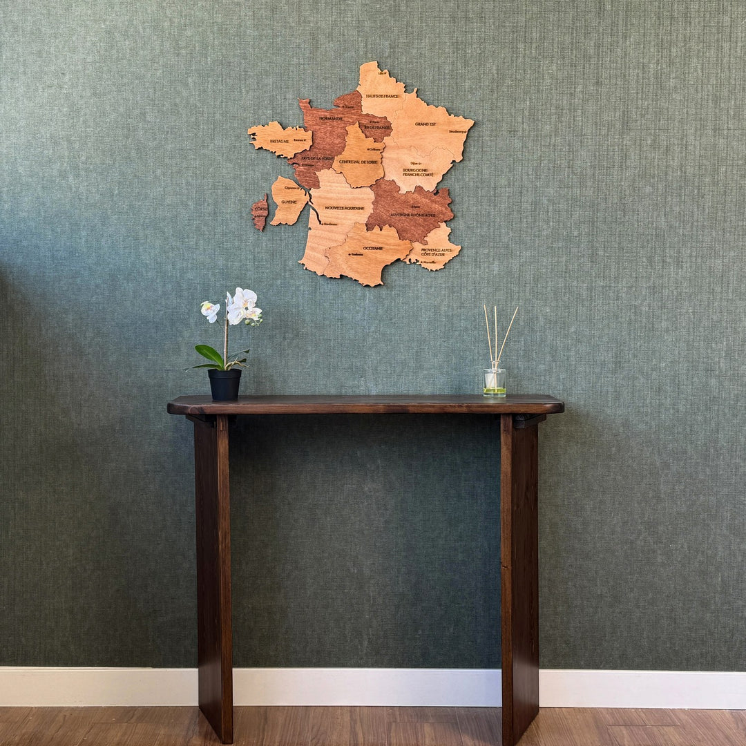 France plywood wall map high above a console table, wide view with white baseboard