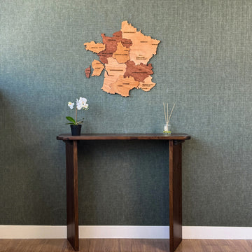 France plywood wall map high above a console table, wide view with white baseboard