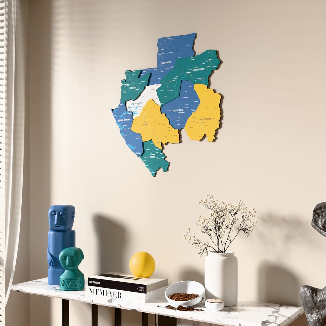 Flag colored Gabon wooden wall map beside a sheer curtain, angled view