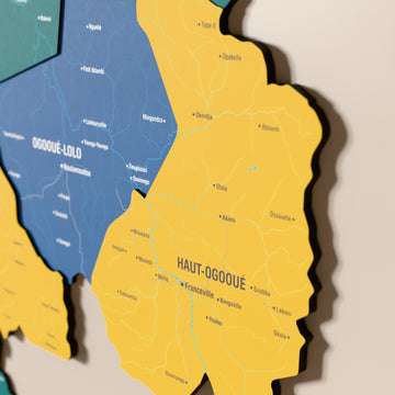 Close-up of the Flag colored Gabon wooden wall map with layered regions and printed names
