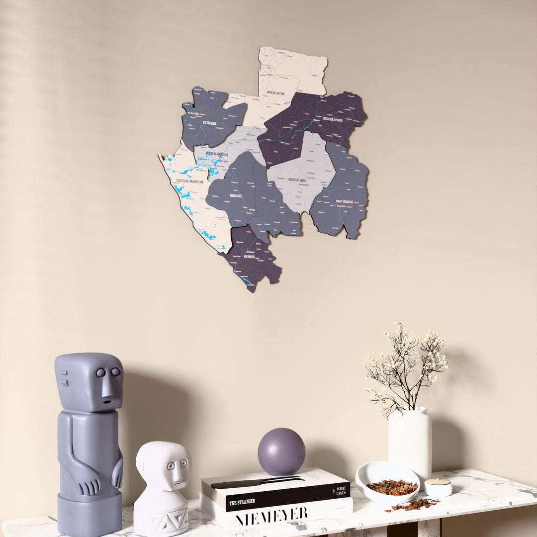 Nimbus Gabon wooden wall map on a beige wall above a console with figurines