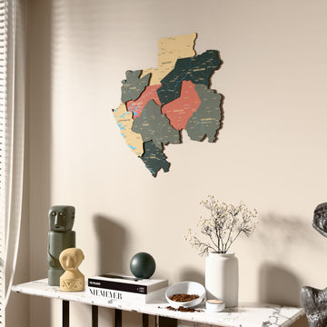 Sage Gabon wooden wall map beside a sheer curtain, angled view