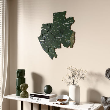 Satellite Gabon wooden wall map beside a sheer curtain, angled view
