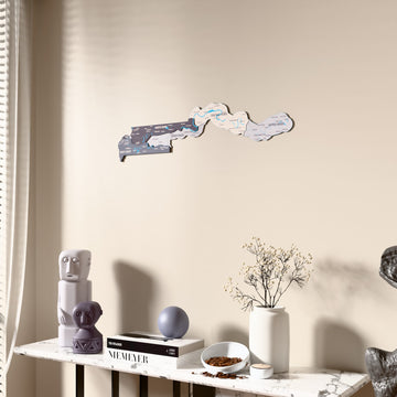 Nimbus Gambia wooden wall map beside a sheer curtain, angled view