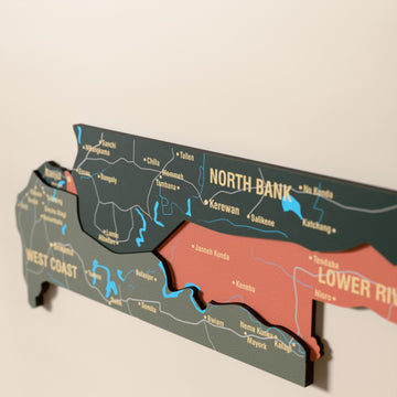 Close-up of the Sage Gambia wooden wall map with layered regions and printed names