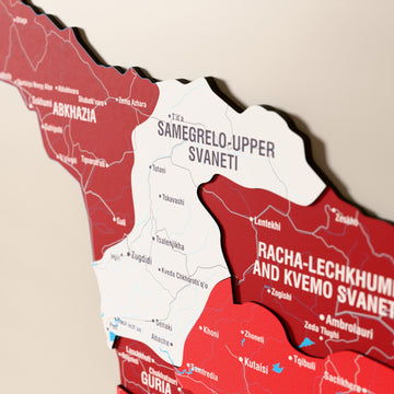 Close-up of the Flag colored Georgia wooden wall map with layered regions and printed names