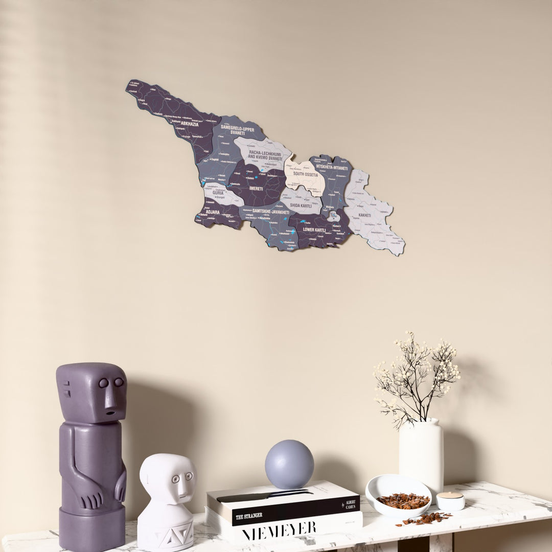 Nimbus Georgia wooden wall map on a beige wall above a console with figurines