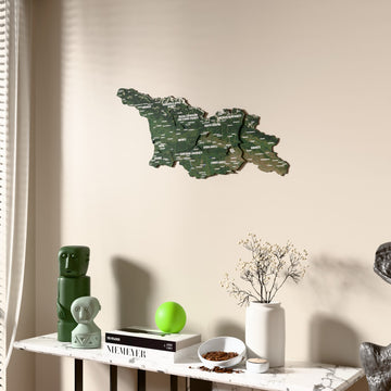 Satellite Georgia wooden wall map beside a sheer curtain, angled view