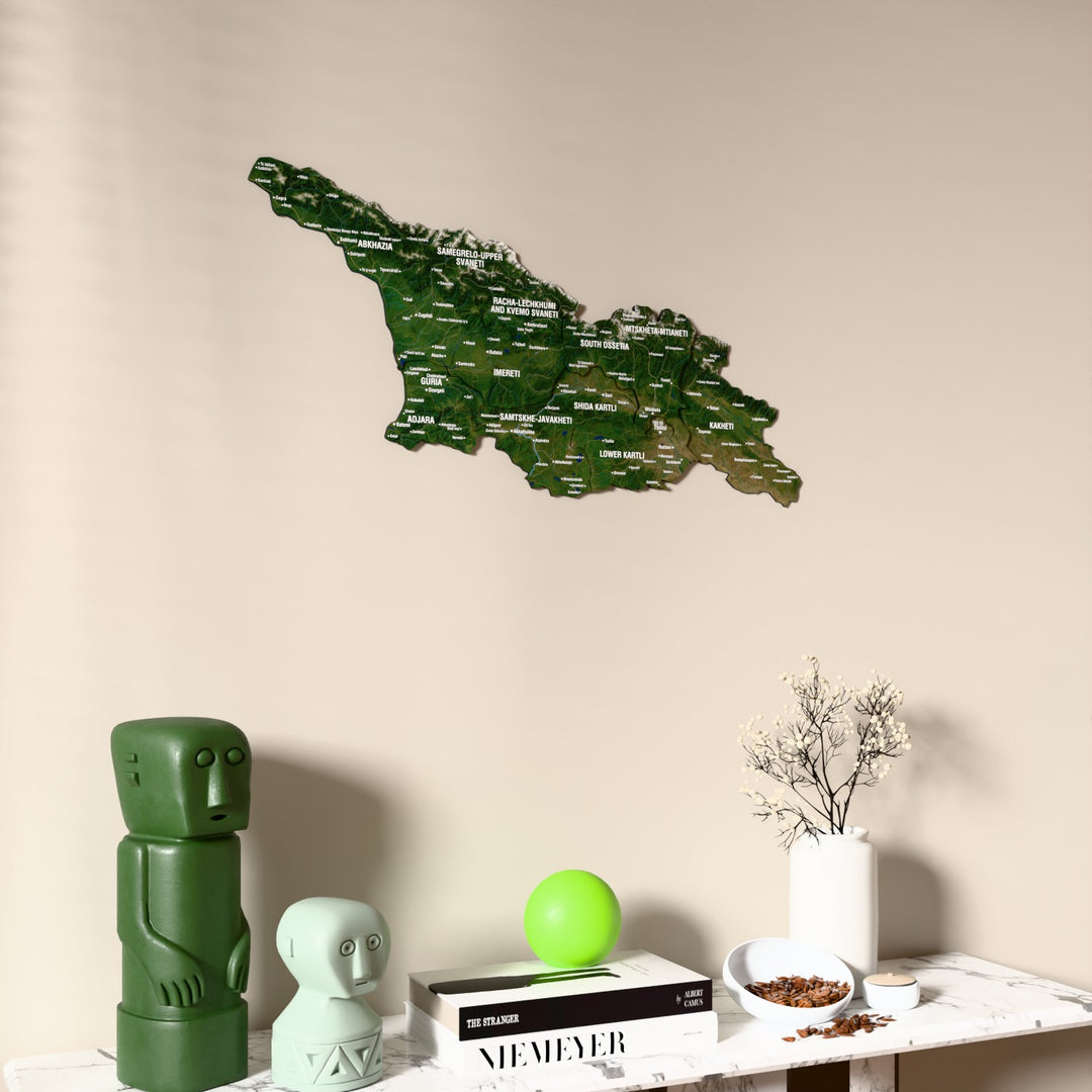 Satellite Georgia wooden wall map on a beige wall above a console with figurines