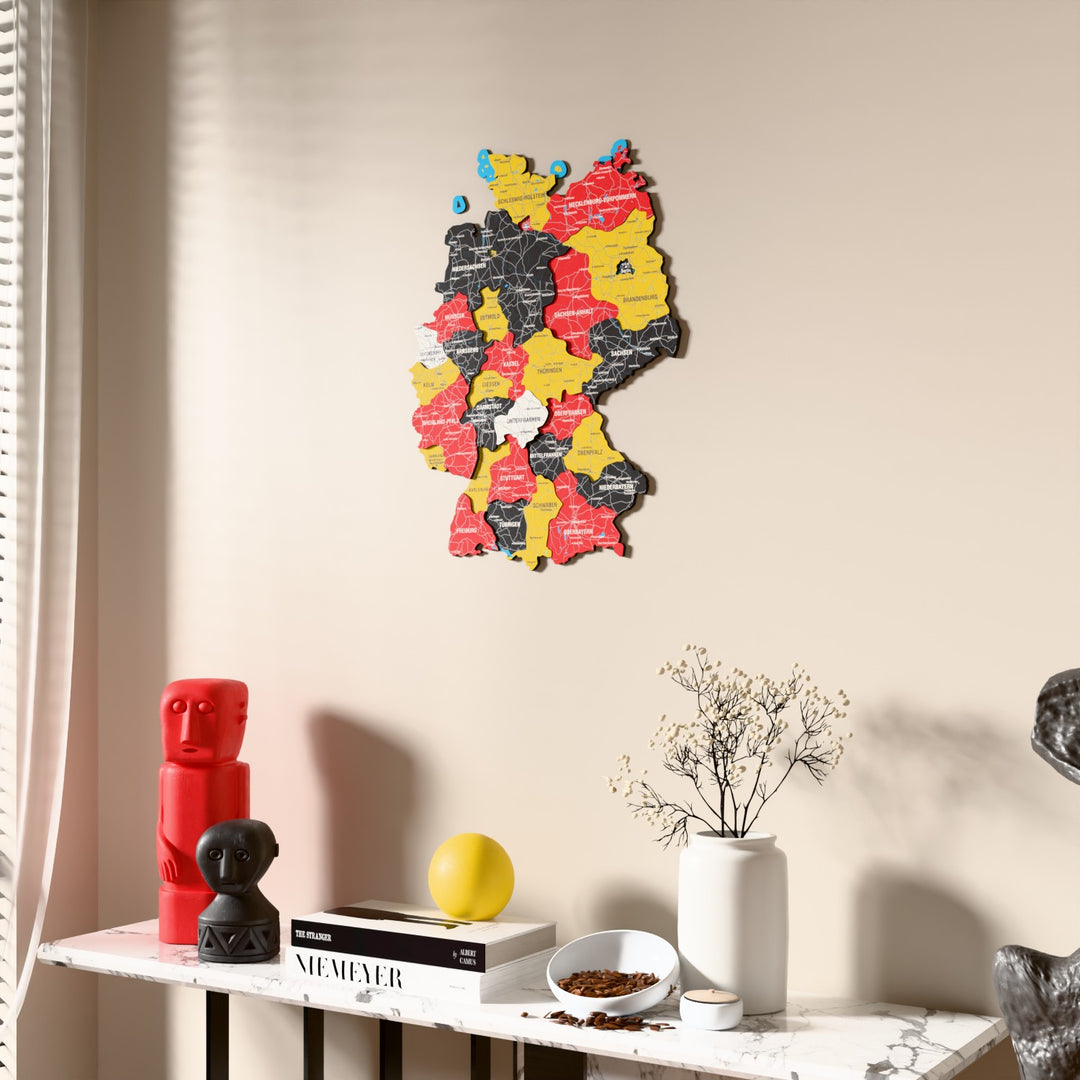 Flag colored Germany wooden wall map beside a sheer curtain, angled view