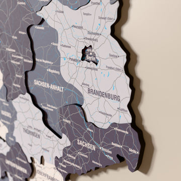Close-up of the Nimbus Germany wooden wall map with layered regions and printed names