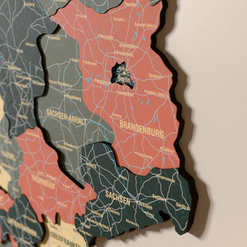 Close-up of the Sage Germany wooden wall map with layered regions and printed names