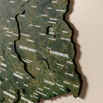 Close-up of the Satellite Germany wooden wall map with layered regions and printed names