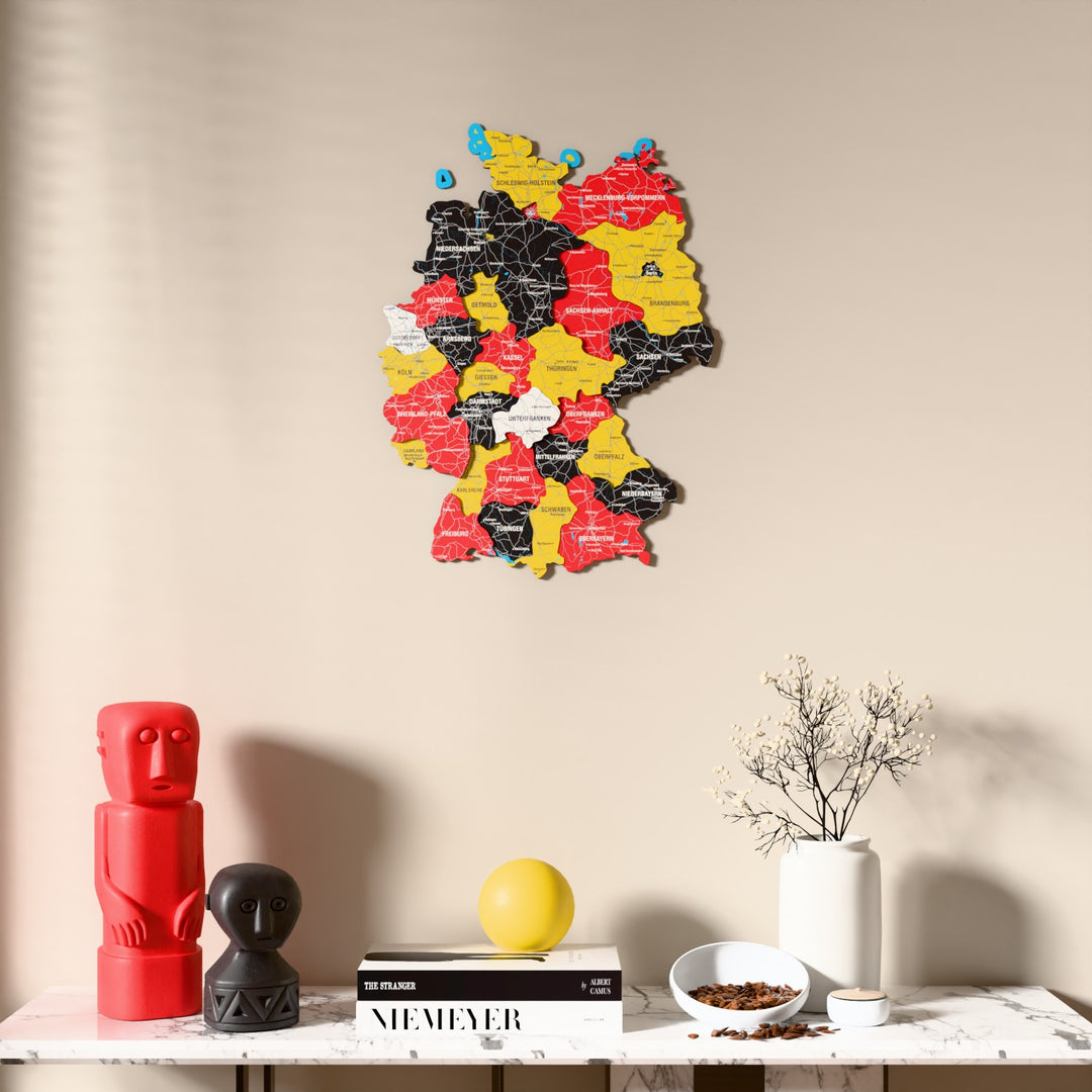 Flag colored Germany wooden wall map above a marble console, front view