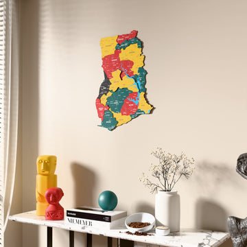 Flag colored Ghana wooden wall map beside a sheer curtain, angled view