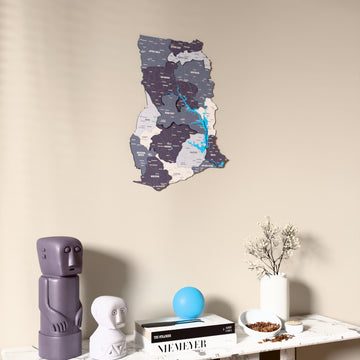 Nimbus Ghana wooden wall map on a beige wall above a console with figurines