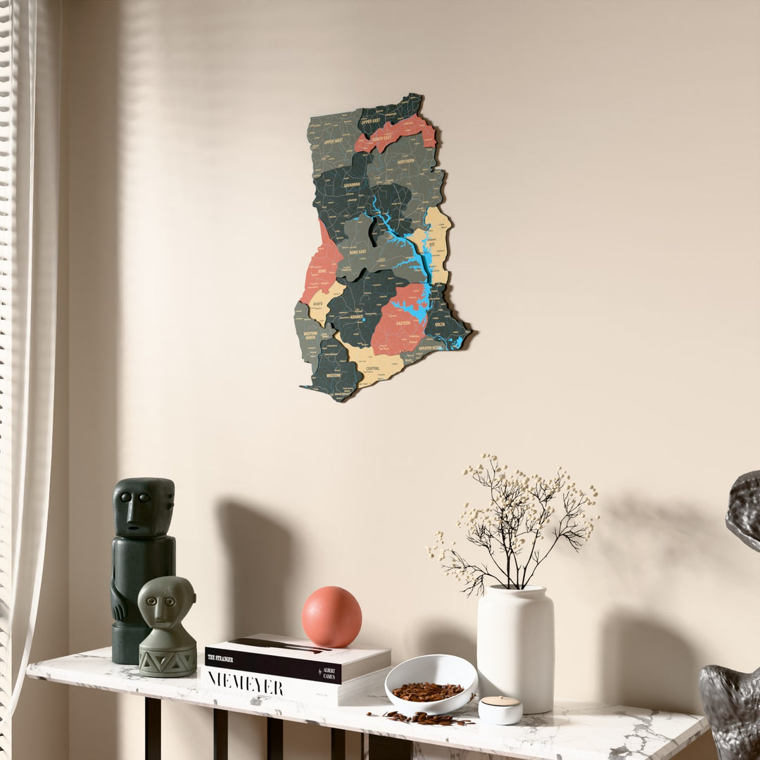 Sage Ghana wooden wall map beside a sheer curtain, angled view