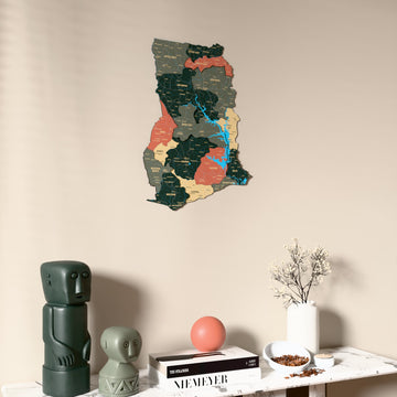 Sage Ghana wooden wall map on a beige wall above a console with figurines