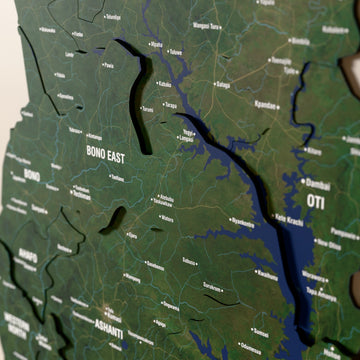 Close-up of the Satellite Ghana wooden wall map with layered regions and printed names
