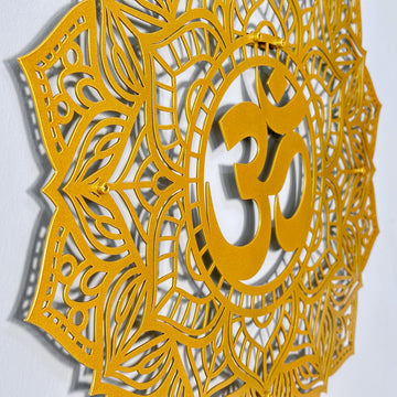 Side-angle close-up of the gold OM mandala metal wall art showing the raised OM symbol and cutout petals