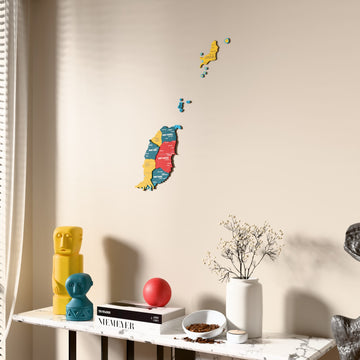 Flag colored Grenada wooden wall map beside a sheer curtain, angled view