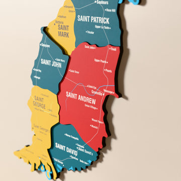 Close-up of the Flag colored Grenada wooden wall map with layered regions and printed names