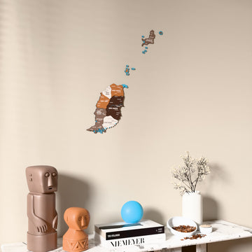 Soil Grenada wooden wall map on a beige wall above a console with figurines