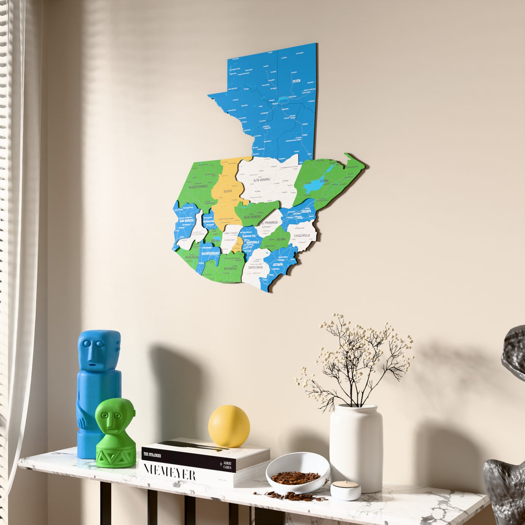 Flag colored Guatemala wooden wall map beside a sheer curtain, angled view