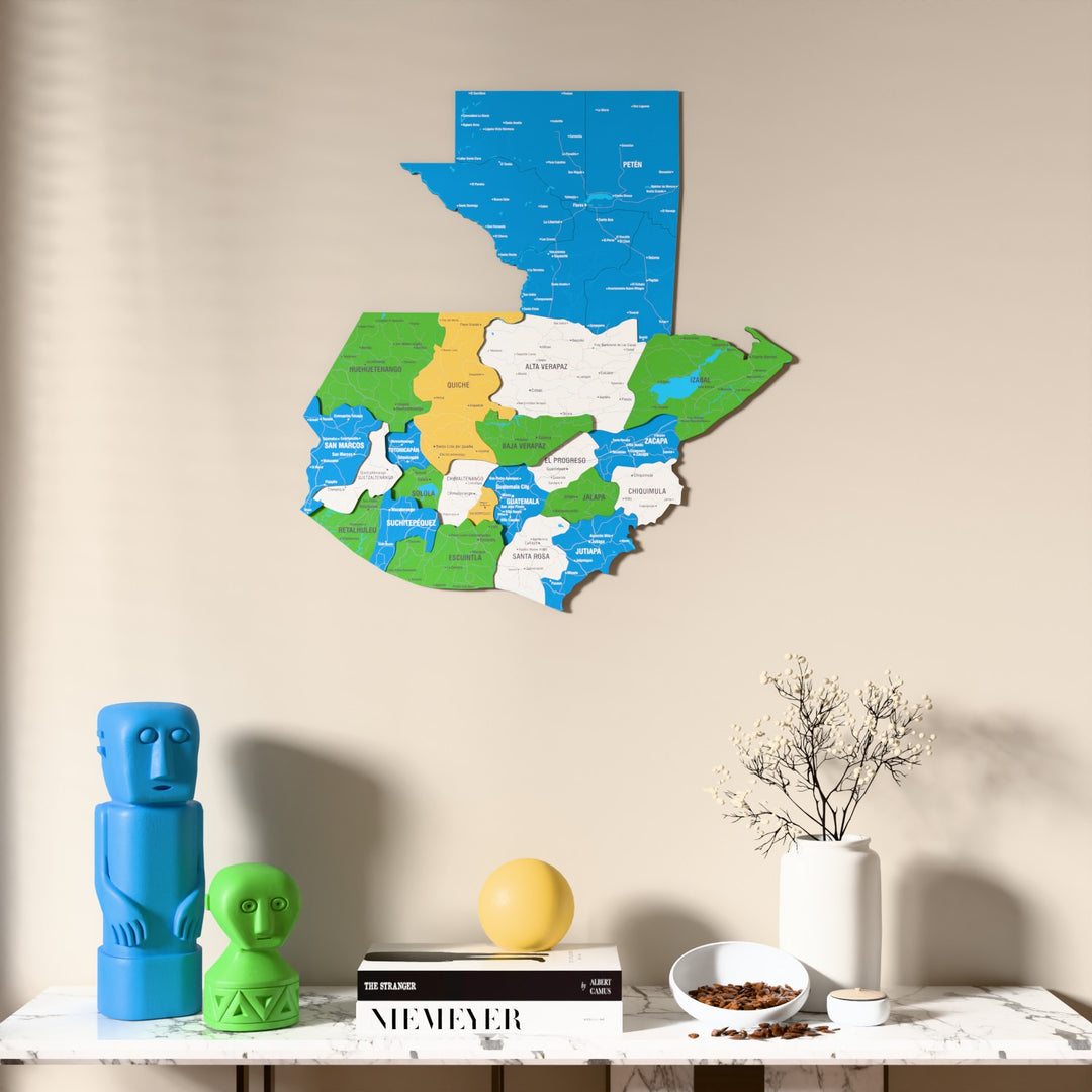 Flag colored Guatemala wooden wall map above a marble console, front view