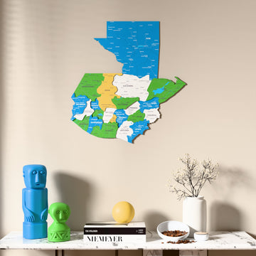 Flag colored Guatemala wooden wall map above a marble console, front view