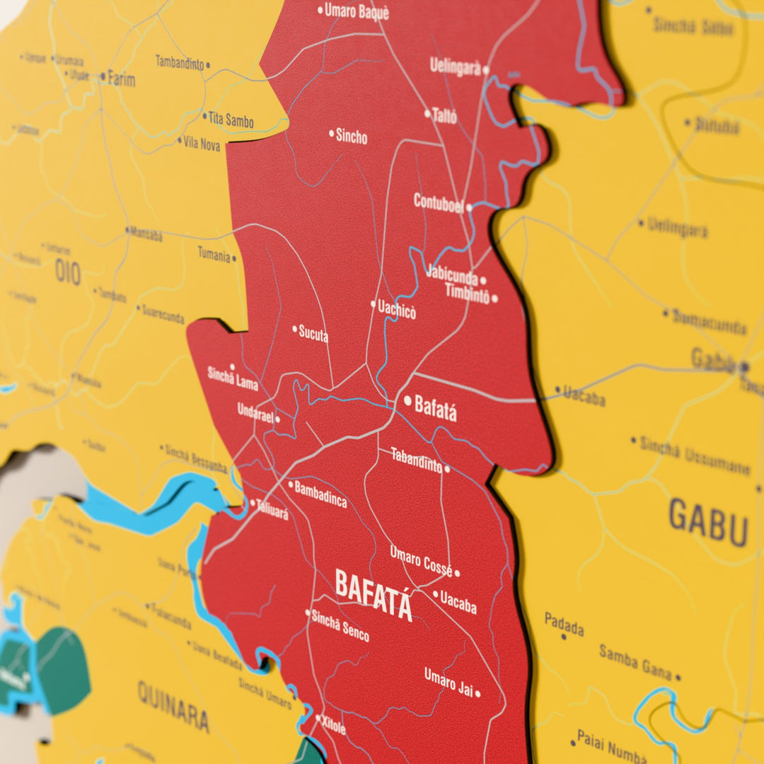 Close-up of the Flag colored Guinea-Bissau wooden wall map with layered regions and printed names