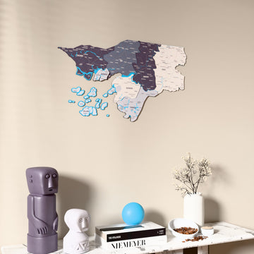 Nimbus Guinea-Bissau wooden wall map on a beige wall above a console with figurines