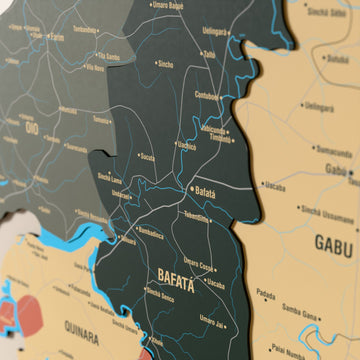Close-up of the Sage Guinea-Bissau wooden wall map with layered regions and printed names