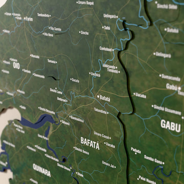Close-up of the Satellite Guinea-Bissau wooden wall map with layered regions and printed names