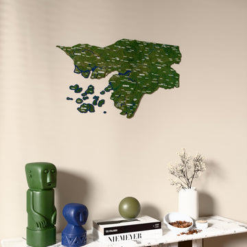 Satellite Guinea-Bissau wooden wall map on a beige wall above a console with figurines