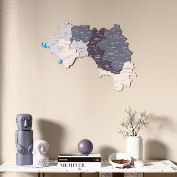Nimbus Guinea wooden wall map above a marble console, front view