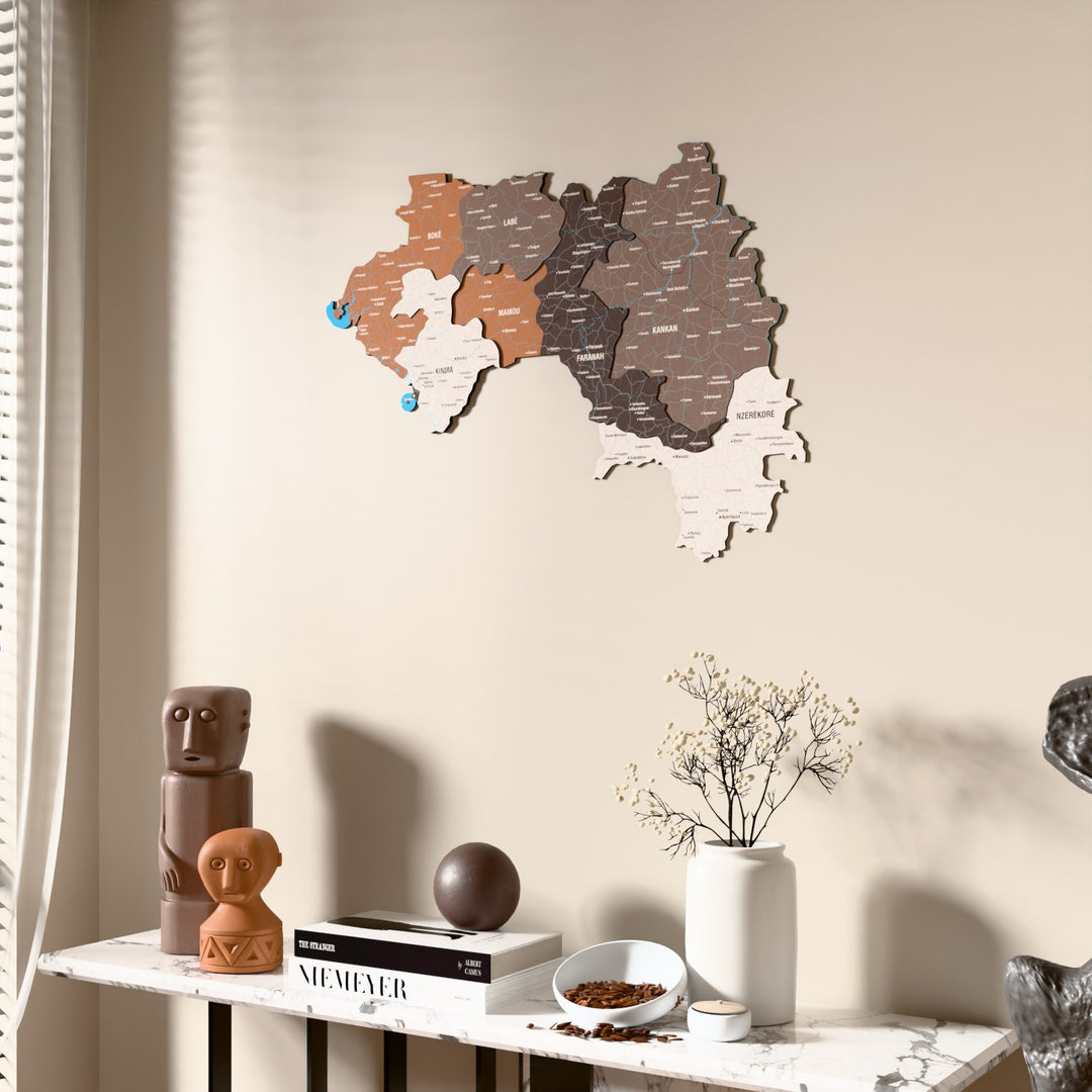 Soil Guinea wooden wall map beside a sheer curtain, angled view