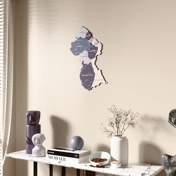 Nimbus Guyana wooden wall map beside a sheer curtain, angled view