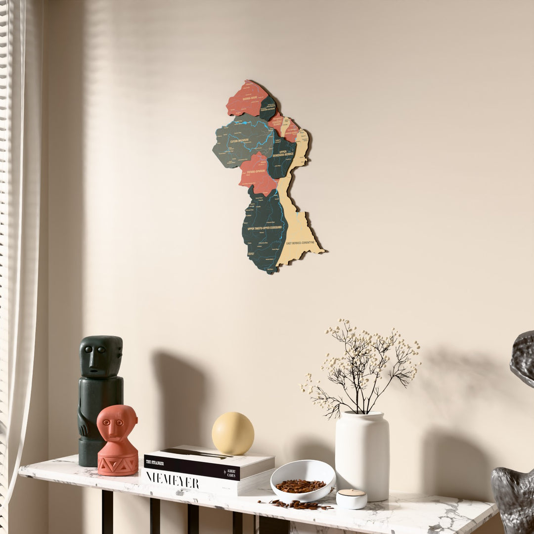 Sage Guyana wooden wall map beside a sheer curtain, angled view