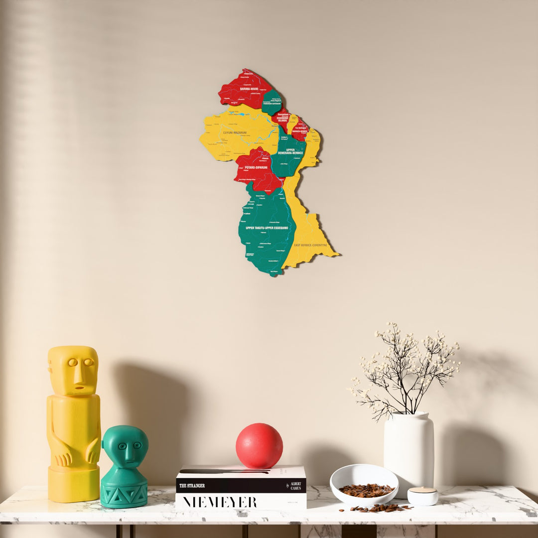Flag colored Guyana wooden wall map above a marble console, front view