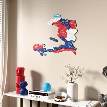 Flag colored Haiti wooden wall map beside a sheer curtain, angled view