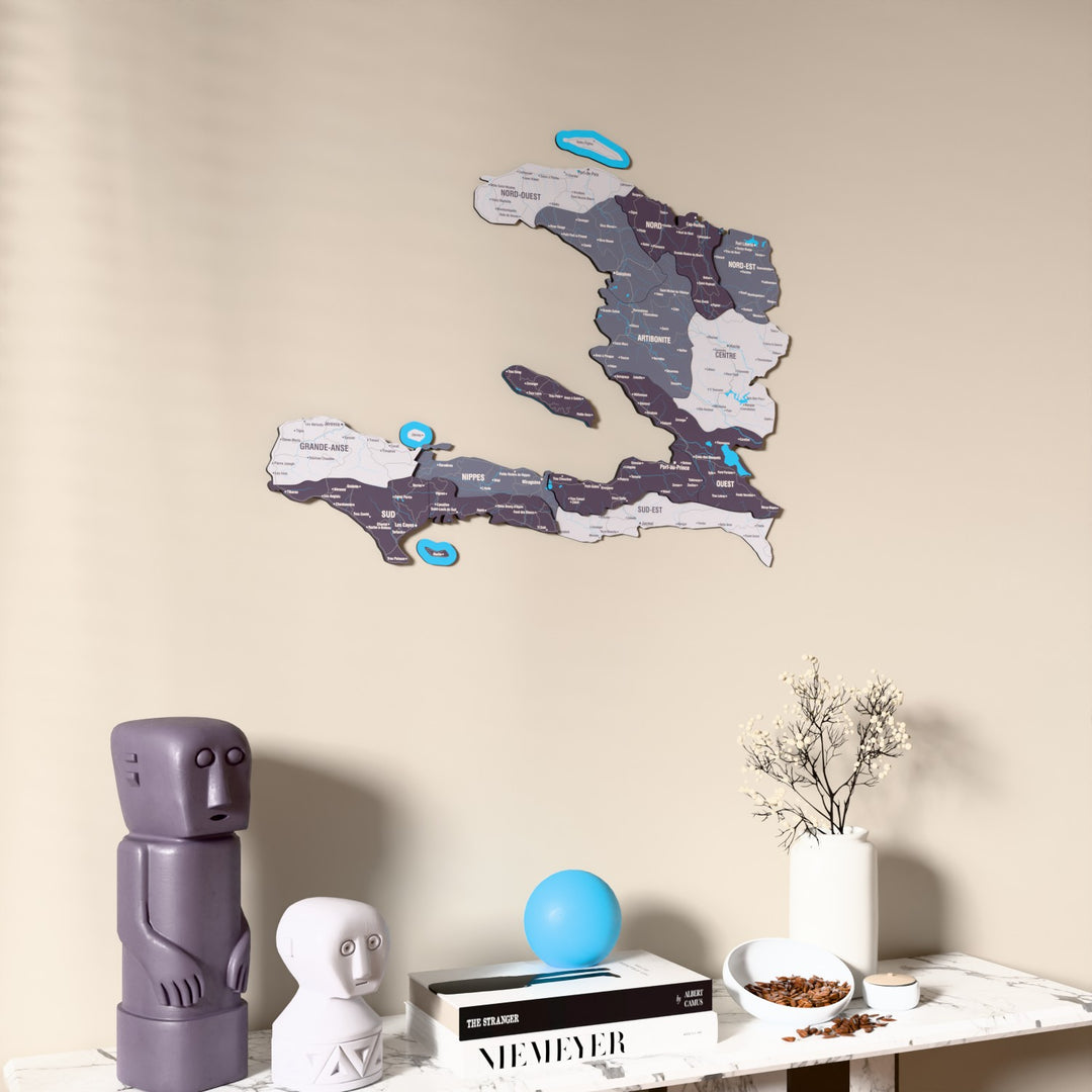 Nimbus Haiti wooden wall map on a beige wall above a console with figurines
