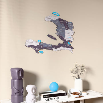 Nimbus Haiti wooden wall map on a beige wall above a console with figurines