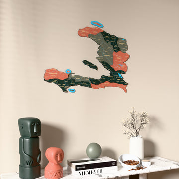 Sage Haiti wooden wall map on a beige wall above a console with figurines