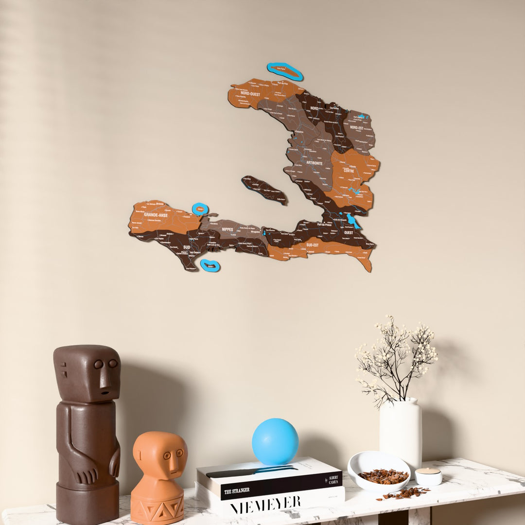 Soil Haiti wooden wall map on a beige wall above a console with figurines