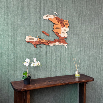 Haiti plywood wall map above a dark console with an orchid, closer view