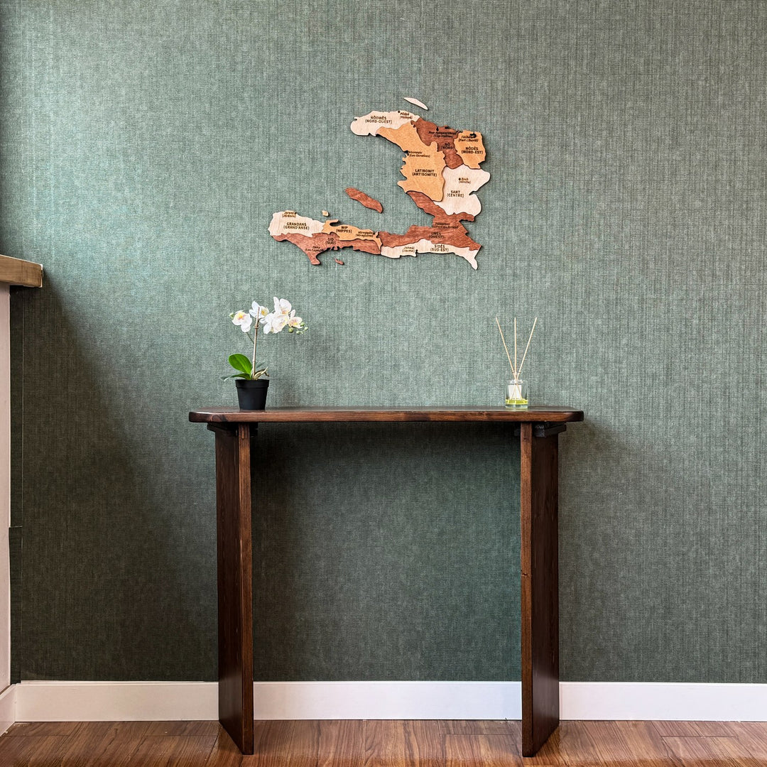 Haiti wood wall map above a tall console table, wide room view with white baseboard